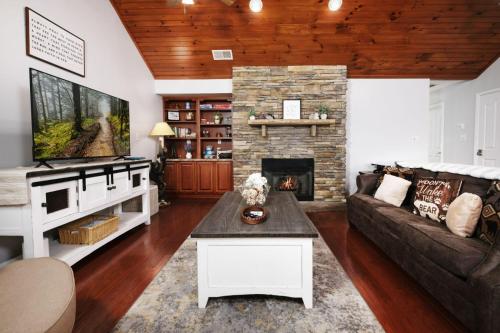 a living room with a couch and a fireplace at Sweet Pea Cottage Updated furnishings arcade game HOA Community Outdoor Pool in Pigeon Forge