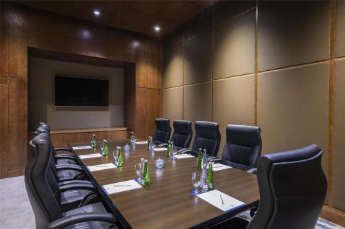 a conference room with a long table and chairs at DoubleTree by Hilton Resort & Spa Marjan Island in Ras al Khaimah