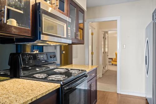 a kitchen with a stove and a microwave at The Drake Hotel in Chicago