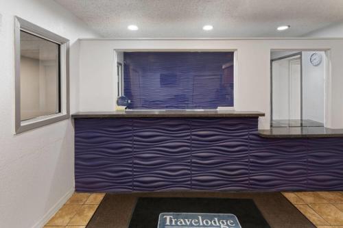 a kitchen with a blue counter and a window at Travelodge by Wyndham New Braunfels in New Braunfels