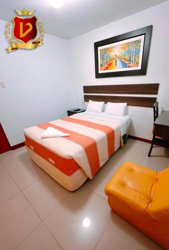 a hotel room with a large bed and a couch at Veneccia Gold Hotel in Chiclayo