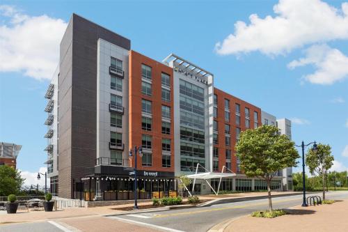 a tall red building on a city street at Hyatt Place National Harbor in National Harbor