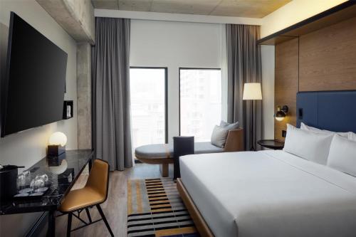 a hotel room with a bed and a desk at Canopy By Hilton Nashville Downtown The Gulch in Nashville
