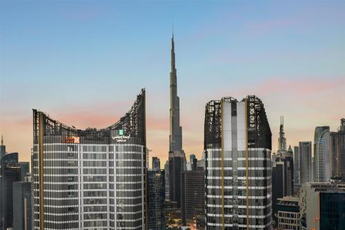 a view of a city skyline with a tall skyscraper at Embassy Suites By Hilton Dubai Business Bay in Dubai
