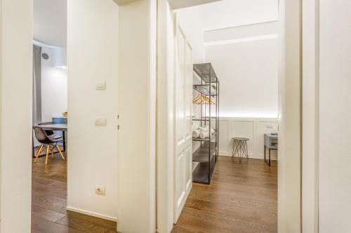 a room with a white door and a table at Next Stop Relax - Near Central Station in Modena