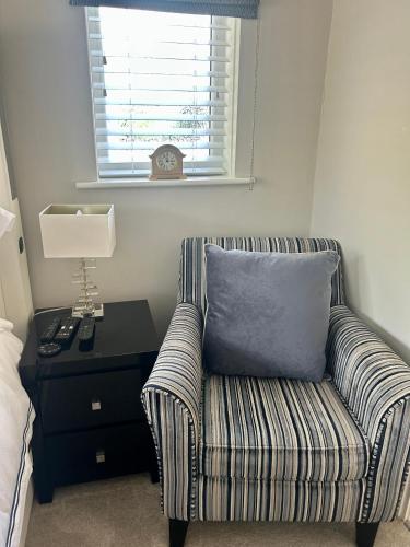 a room with a couch and a pillow on a table at Wendys house in Sarisbury Green