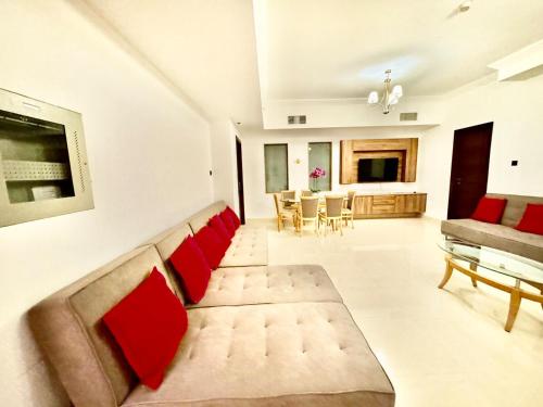 a living room with a couch and a table at JSCOM GRAND Residence in Dubai