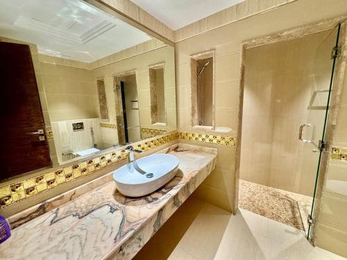 a large bathroom with a sink and a shower at JSCOM GRAND Residence in Dubai