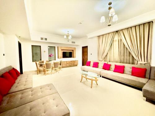 a living room with a couch and a table at JSCOM GRAND Residence in Dubai