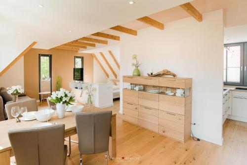a kitchen and dining room with a table and chairs at Weidestr 18 Wohnung 2 ( Captains' finest) in Heiligenhafen