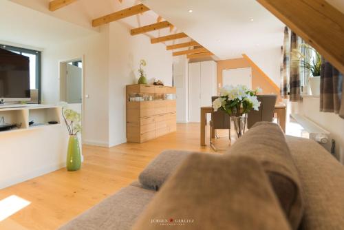 a living room with a couch and a table at Weidestr 18 Wohnung 2 ( Captains' finest) in Heiligenhafen