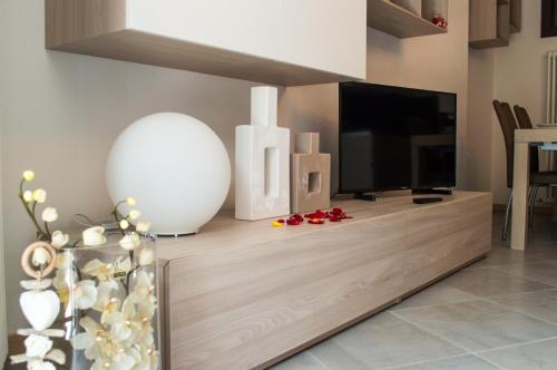 a living room with a flat screen tv on a entertainment center at Residenza Belvedere in Premana