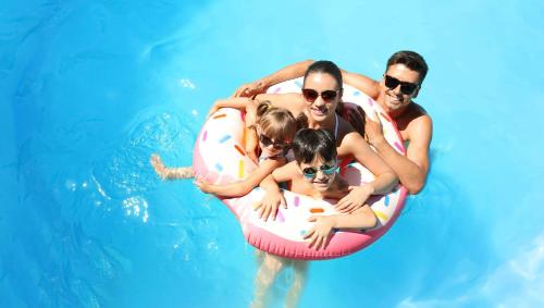 a group of people in a swimming pool at Magnuson Hotel Sand Springs – Tulsa West in Sand Springs
