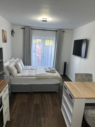 a bedroom with a bed and a television in it at Little side house in Cambridge in Trumpington
