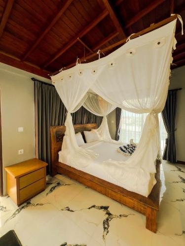 a bedroom with a bed with a mosquito net at Japa Guesthouse in Canggu