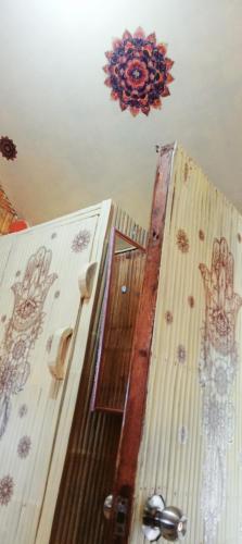 a wooden room with a wall with drawings on it at PINOY YOGA POLE PIYOPO LA UNION fan kubo 4 pax in Rimus