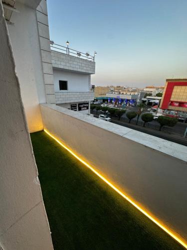 a balcony with green grass and lights on a building at شقق دخول ذاتي in Taif