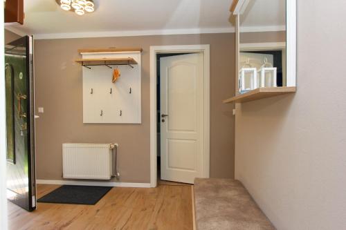 un couloir avec une porte et une horloge sur le mur dans l'établissement Madleen, à Wieck