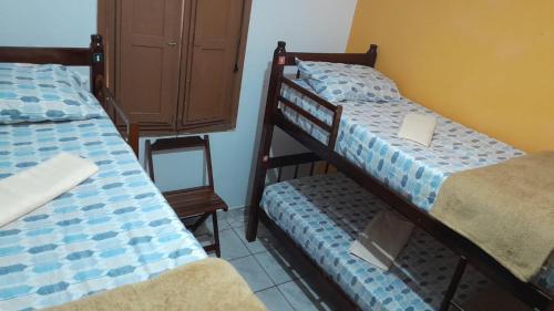 a bedroom with two bunk beds with a laptop on it at Trem Bão de Dormir in Recife