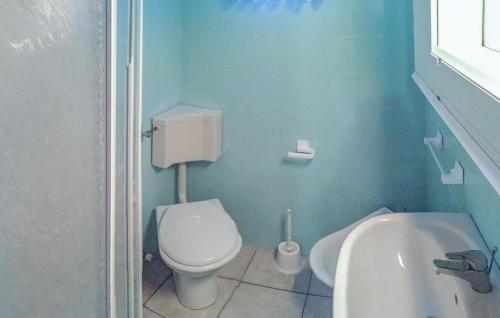 a blue bathroom with a toilet and a sink at Appartamento Trilocale in Rosapineta