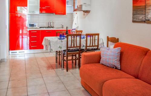 a living room with a couch and a table and a kitchen at Appartamento Trilocale in Rosapineta