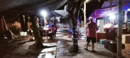 a group of people standing on a street at night at PINOY YOGA POLE PIYOPO LA UNION fan kubo 4 pax in Rimus