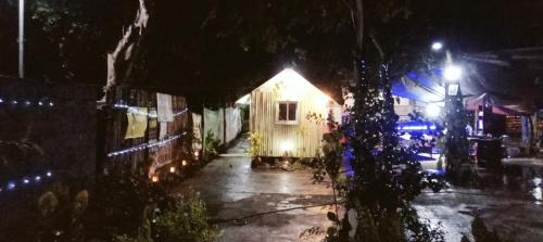 a house with lights on a street at night at PINOY YOGA POLE PIYOPO LA UNION fan kubo 4 pax in Rimus