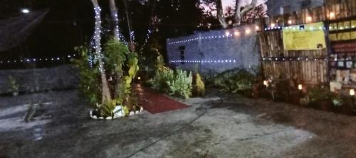 a building with a fountain in a courtyard at night at PINOY YOGA POLE PIYOPO LA UNION fan kubo 4 pax in Rimus