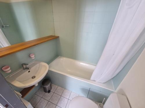 a bathroom with a sink and a tub and a toilet at L'Auberge de Mens in Mens