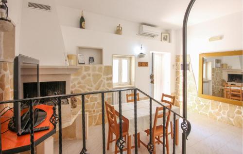a dining room with a table and a fireplace at Cozy Home In Ostuni With Wifi in Ostuni