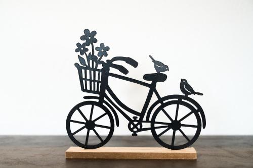 a metal bike with birds on it on a wooden stand at Wirtseppelerhof Apartments in Leutasch