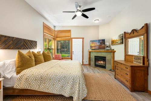 a bedroom with a bed and a fireplace at Cozy Pine Cabin Pool Access in Ronald