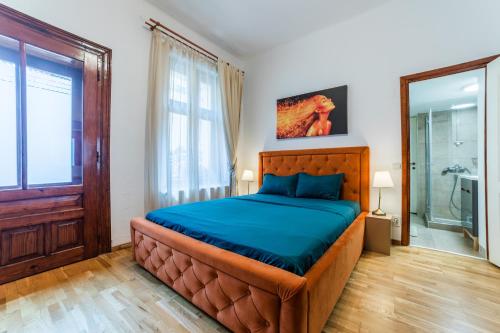 a bedroom with a large bed and a glass shower at Old City Lux 2 in Braşov