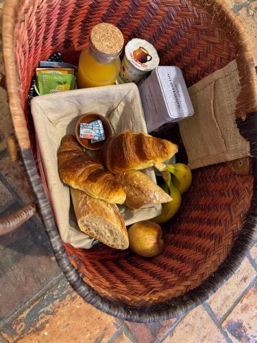 a basket with bread and other foods in it at Le Refuge du Tournapile - La Halte in Saint-Léger-Dubosq
