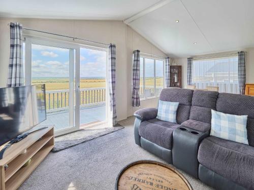 a living room with a couch and a flat screen tv at Host & Stay - Clearwater Willerby Lodge in Isle of Sheppey