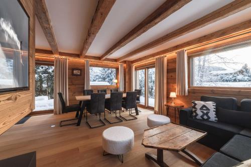 un soggiorno con un divano e un tavolo di Pas de l’Ourson - Megève - Chalet with Sauna a Megève