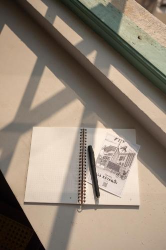 a pen sitting on top of a notebook on a table at La Sataqui in Cansaulim