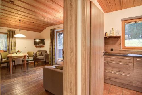 a living room with a couch and a table at Ferienwohnungen Kimpfbeck, Kreuth-Schärfen in Kreuth