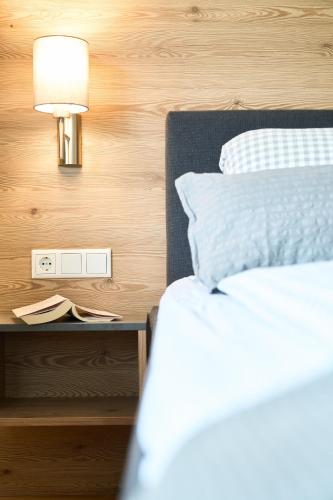a bedroom with a bed and a lamp on a night stand at Wirtseppelerhof Apartments in Leutasch