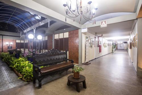a hallway with a bench and plants in a building at Amuarama Hotel in Fortaleza