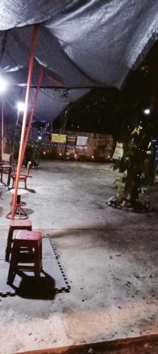 a group of benches sitting under a tent at night at PINOY YOGA POLE PIYOPO LA UNION fan kubo 4 pax in Rimus
