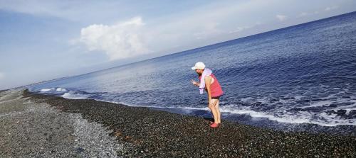 a woman standing on the beach near the ocean at PINOY YOGA POLE PIYOPO LA UNION fan kubo 4 pax in Rimus