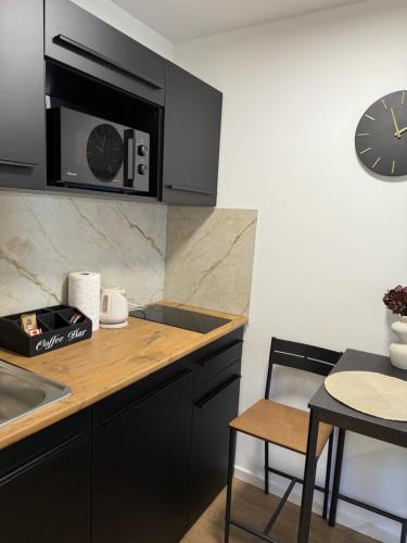 a kitchen with a counter and a clock on the wall at Stellar Otavice in Otavice