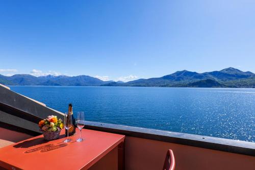a table with a bottle of wine and a glass at Yachting Residence in Ghiffa
