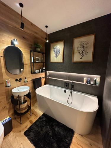 a large white bath tub in a bathroom at Apartmán Máj 104 in Pec pod Sněžkou