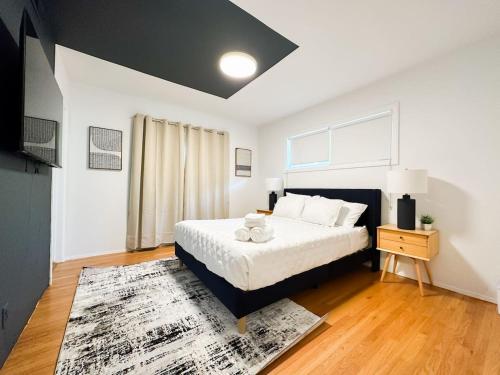 a bedroom with a large bed and a rug at 6BR Pool Escape for Friends and Family - LOU1 - BUR in Burbank