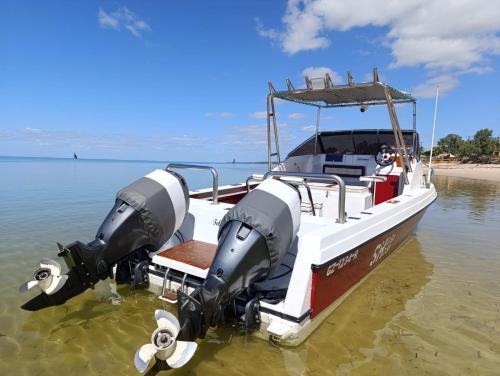 a boat in the water with a drone on it at Telvina Beach Lodge in Vilanculos