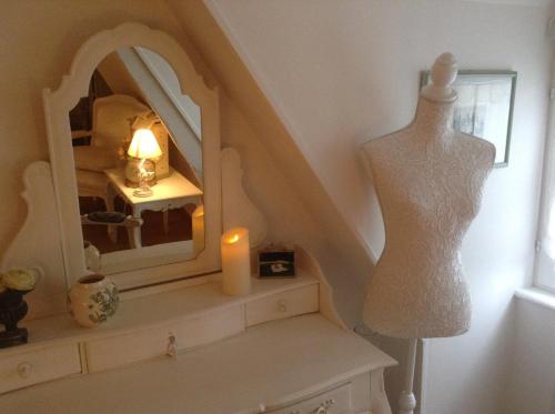a dress mannequin and a mirror on a shelf at Lamaison du phare honfleur chambres d'hotes et jacuzzi privé in Honfleur