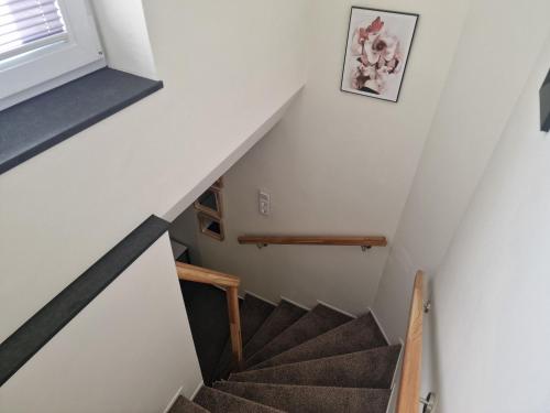 a staircase in a home with white walls and a stair case at FEWO am Rathaus in Heimbach