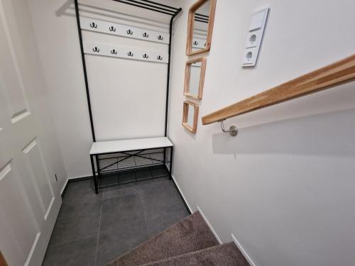 a stairway with a white wall and a white closet at FEWO am Rathaus in Heimbach